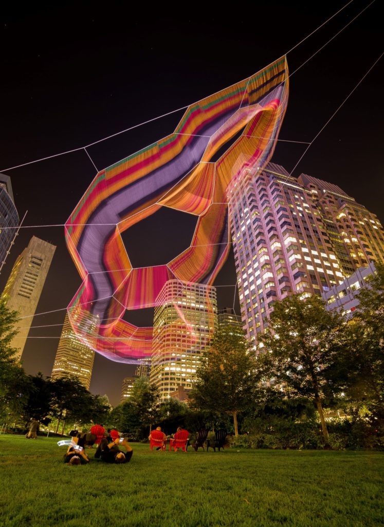 Janet Echelman's aerial sculpture over the Rose Kennedy Greenway from below at night.