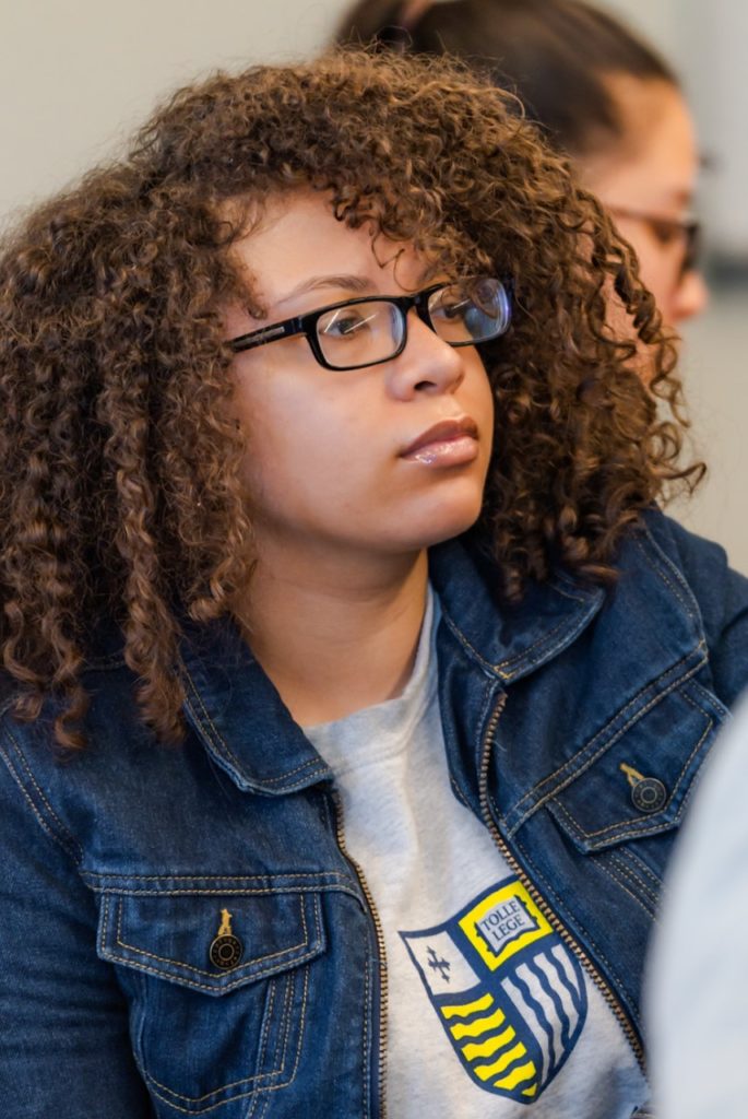 A female Early College student listens during class at Merrimack College.